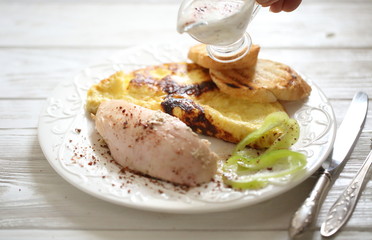 Baked chicken breast with spices and scrambled eggs with croutons