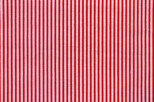 Red and white striped fabric texture. Bright colored cotton background