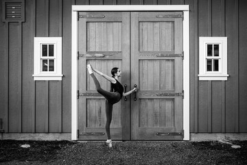 dancer in front of a country ranch door.