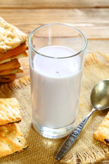 Yogurt with cookies on a wooden background