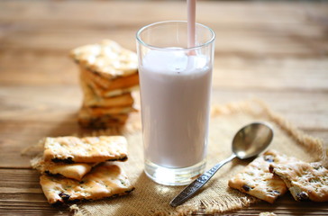Yogurt with cookies on a wooden background