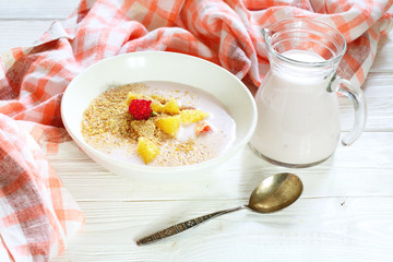 Yogurt with flax seeds, grapefruit, raspberries and orange on a white background
