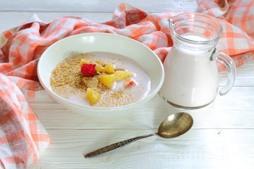 Yogurt with flax seeds, grapefruit, raspberries and orange on a white background