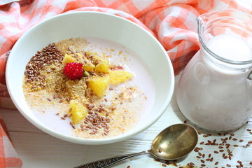 Yogurt with flax seeds, grapefruit, raspberries and orange on a white background