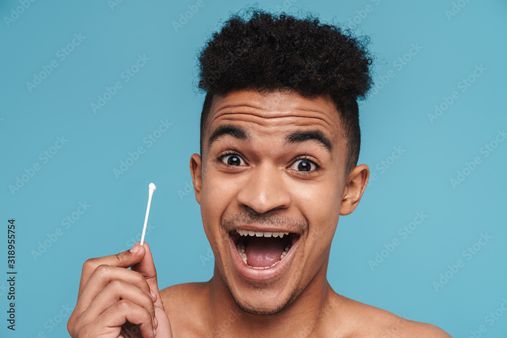 Poster Photo of excited african american man holding cotton swab and smiling