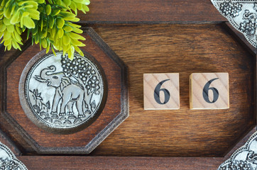 Number 66, Numbercube design with wooden board for background.