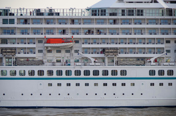 View of starboard side of luxury cruise ship liner or cruiseship with life boats, balcony cabins...