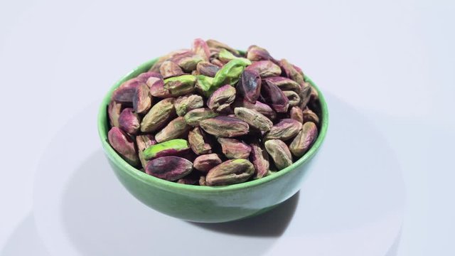 Rotation of emerald green pistachio nuts from Bronte, Sicily, Italy