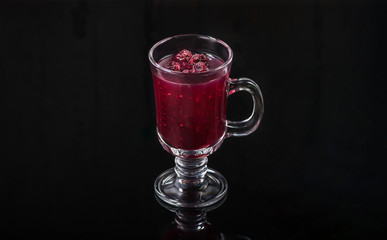 a hot drink in a glass on a dark background