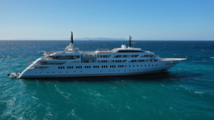 Aerial drone top down photo of luxury yacht docked in Mediterranean destination port with deep blue...