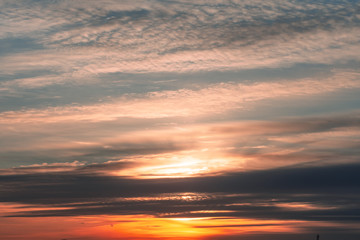 Fototapeta na wymiar Evening sunset sky with dark clouds near the horizon.