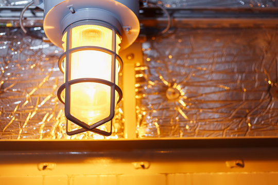 Industrial explosion proof lantern of black and gray shines with white light at coal mining exhibition