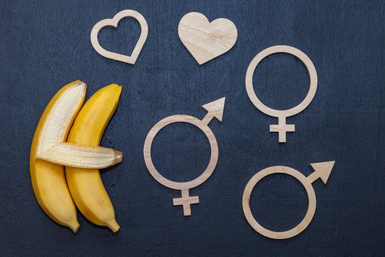 Sex education concept-letters, two bananas on a chalkboard. Free choice.