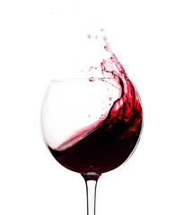 Splash of red wine in a glass isolated on  white.