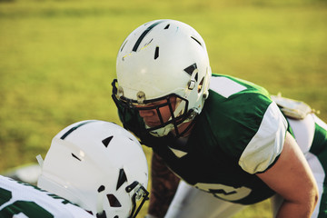 Two football players lining up for defensive drills during pract
