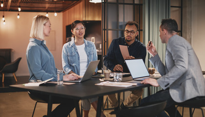 Diverse group of businesspeople talking together in an office