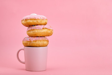 Colorful donuts breakfast composition with different color styles of donuts and fresh coffee on...