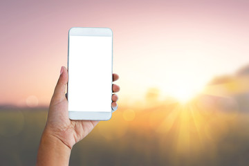 hand hold smart phone and sunrise