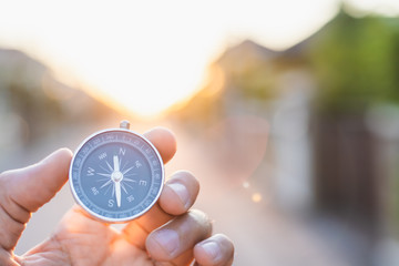 man holding compass on blurred background. for activity lifestyle outdoors freedom or travel tourism and inspiration backpacker alone tourist travel or navigator image. - obrazy, fototapety, plakaty