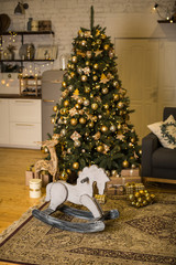 Christmas interior with elegant Christmas tree and rocking horse