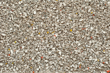 The texture of the wall is made of small yellow, red and white stones.