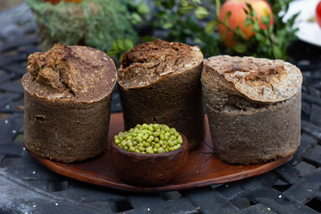 Buckwheat bread with tomatoes at bush background