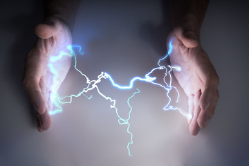 Energy and lightning in hands of healer or magician.