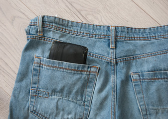 Brown wallet in the blue jeans pocket