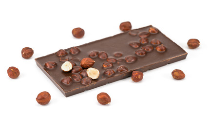 Chocolate with hazelnuts on white background.