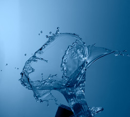 blue color water splash isolated on empty background, studio photo