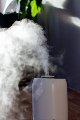 white humidifier in a home interior in sunlight