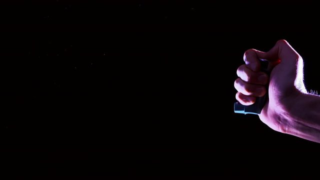 asthma inchalator on a black background, in slow motion