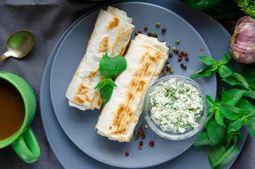 Healthy breakfast: pancakes with cottage cheese and dill lie on a round plate
