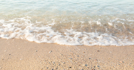Soft wave of blue ocean on sandy beach. Background.