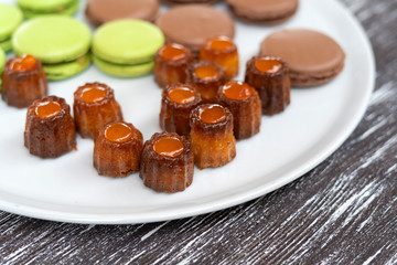Cookies of pasta, green and brown colors, as well as other sweets, are laid out on a plate-2.