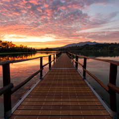 Fototapeta na wymiar Wonderful sunset with a pier at Lago di Varese in Italy during summer