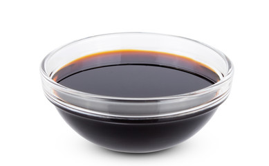 Soy sauce in transparent glass bowl isolated on white background