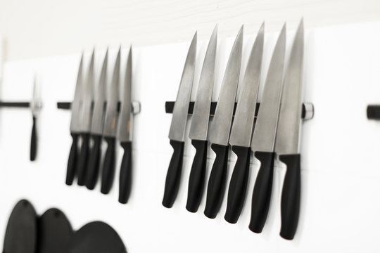 Set Of Kitchen Knives On Magnetic Tapes In The Kitchen