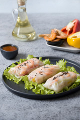 Vietnamese food spring rolls with shrimps on grey. Close up. Asian cuisine. Vertical format.