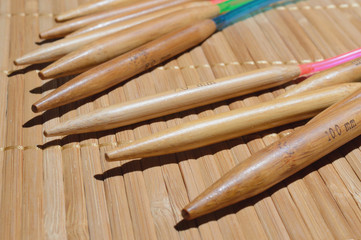 circular bamboo knitting needles on a wooden surface.