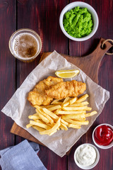Fish and chips on a wooden background. British fast food. Recipes. Snack to beer. English cuisine.