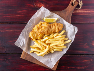 Fish and chips on a wooden background. British fast food. Recipes. Snack to beer. English cuisine.