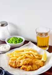 Fish and chips on a wooden background. British fast food. Recipes. Snack to beer. English cuisine.