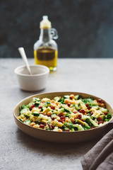 Quinoa salad with chickpeas, cucumber, avocado, parsley and pomegranate seeds