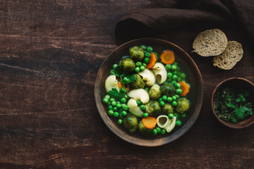 Seasonal Italian minestrone soup with pasta, brussels sprouts, carrots and peas