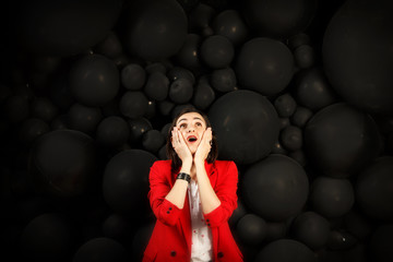Young woman with a sad face. girl in difficult circumstances. Everything is bad. Woman in red on black bubble background. Copy space