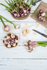 Raw Vegetables Fresh Harvest. Garlic Cloves and Garlic Bulb on a white wooden rustic table