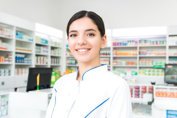 smart and confident young woman pharmacist smiling. the face of the company