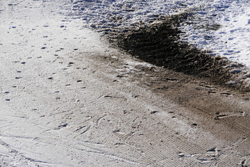 Partial melting of snow, a patch, spot or puddle of sand or ground from under the snow. The arrival of spring, dirty way.