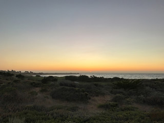 Looking out over the Pacific Ocean at sunset in Carmel, California